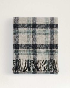 a black and white plaid blanket with fringes