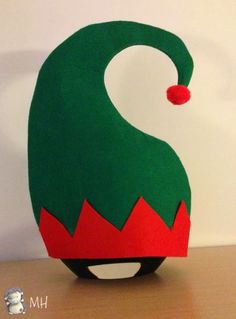 an ornament made to look like a green monster's head with a red nose