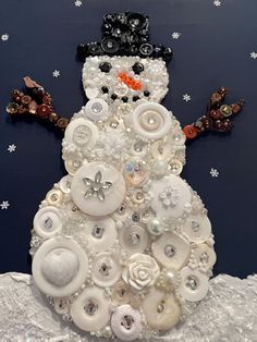 a snowman made out of buttons and other items