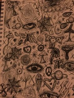 a notebook with drawings on it and an eye drawn in the middle by someone's hand