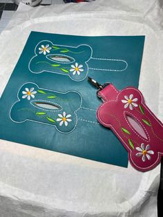 a pair of scissors sitting on top of a piece of paper next to some flowers