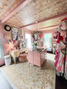 a room with pink walls and furniture in it