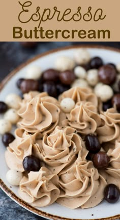 a white plate topped with hummus and olives covered in peanut buttercream