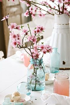 pink flowers in a mason jar on a table