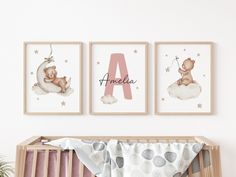 a baby's room with three framed pictures on the wall