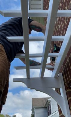 a man is climbing up the side of a building