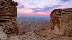 the sun is setting over canyons in the desert