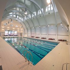 an indoor swimming pool in a large building