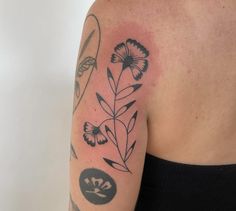 a woman with a flower tattoo on her arm