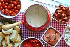 a table topped with bowls filled with different types of food next to bread and veggies