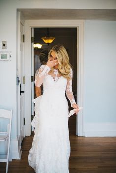 a woman in a wedding dress is taking a selfie