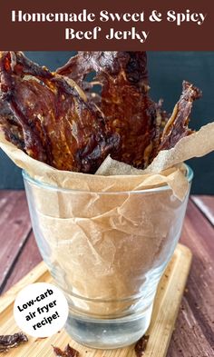 some kind of food in a glass on a wooden table