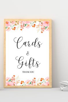 a card and gifts sign sitting on top of a shelf