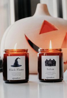 two candles sitting next to each other on a table