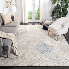 a living room filled with furniture and a large rug