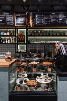 a bakery filled with lots of desserts and pastries on top of glass shelves