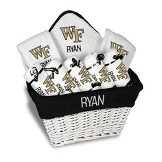 a white basket filled with towels and personalized wipes on top of each other