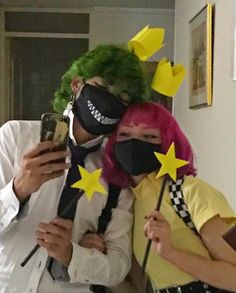 two people wearing masks with stars on them