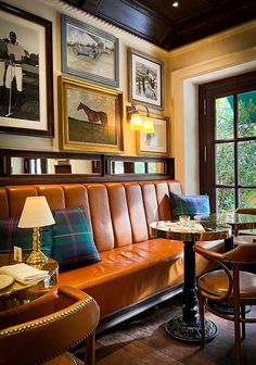 a living room filled with furniture and pictures on the wall