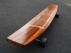 a wooden skateboard sitting on the ground