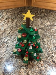 a christmas tree made out of cupcakes on top of a granite countertop