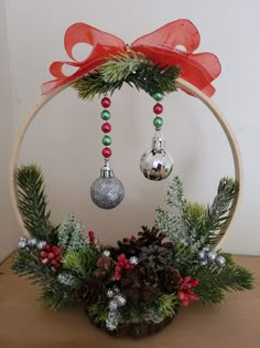 a christmas wreath with ornaments hanging from it