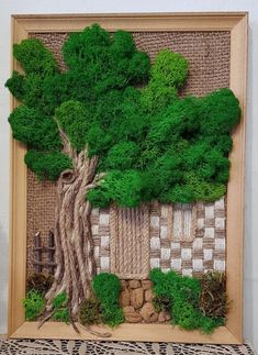 an art work made out of wood and moss