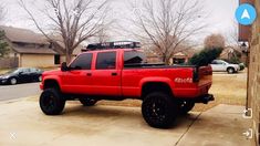 a red pick up truck parked in front of a house