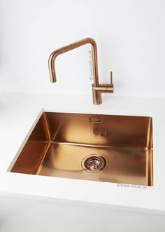 a kitchen sink with a faucet in the middle and a drain on the side