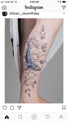 a bird sitting on top of a woman's leg with flowers and leaves around it