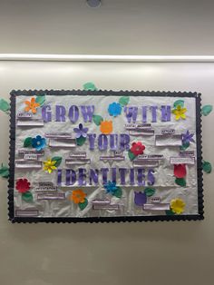 a bulletin board that says grow with your identities