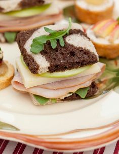 sandwiches with meat, cheese and vegetables on a plate