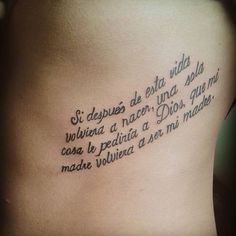 the back of a woman's stomach with words written in cursive writing