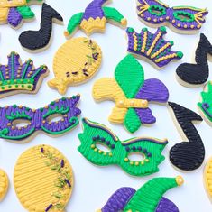 decorated cookies with mardi gras and masks on them are displayed for the camera