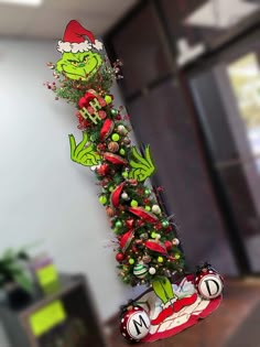 the grinch christmas tree has been decorated with candy canes and candies on it