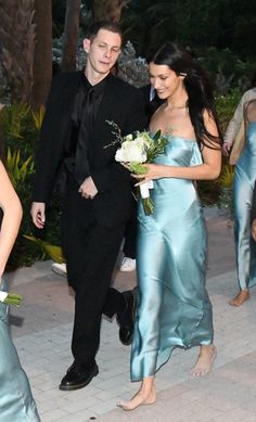 a man and woman in formal wear walking together