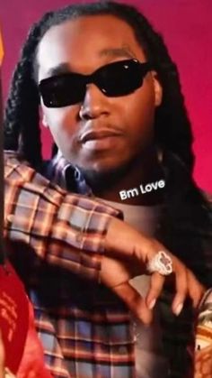 a man wearing sunglasses and holding a cell phone in his right hand with the words em love on it