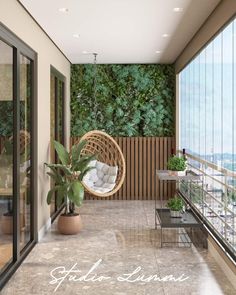 a balcony with a hanging chair, potted plant and glass doors leading to the outside