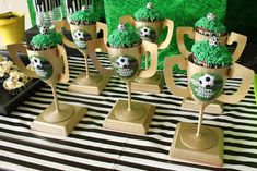 cupcakes with green frosting and soccer decorations