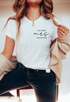 a woman sitting on a chair wearing a white shirt