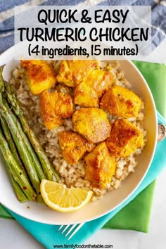 a white plate topped with rice and chicken next to asparagus on a blue napkin