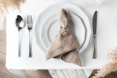 a white plate topped with a napkin and silverware