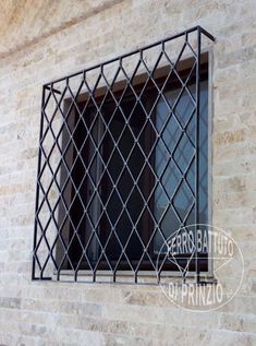 an iron window on the side of a building