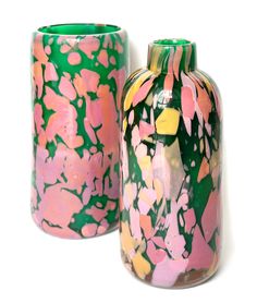 two colorful vases sitting next to each other on a white surface with pink, green and yellow designs