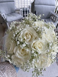 a bouquet of white roses and baby's breath