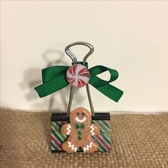 a christmas ornament with a candy cane in the shape of a gingerbread