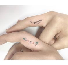 two people with matching tattoos on their fingers