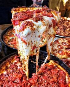 a slice of deep dish pizza being lifted from a pan