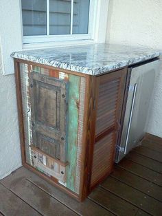 an old cabinet with marble top sitting outside