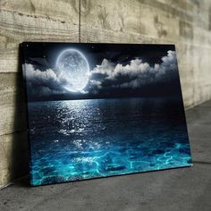 an ocean scene with the moon in the sky and water below it, on a wooden wall